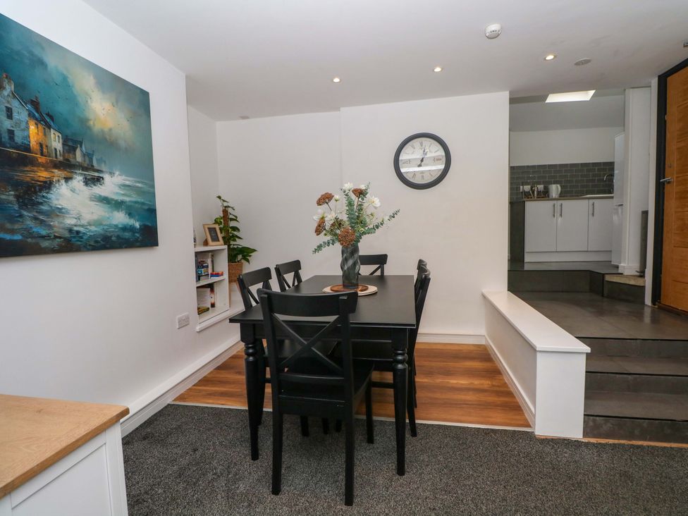 A dining room with a table and chairs at Broad Beams Parkgate near Neston