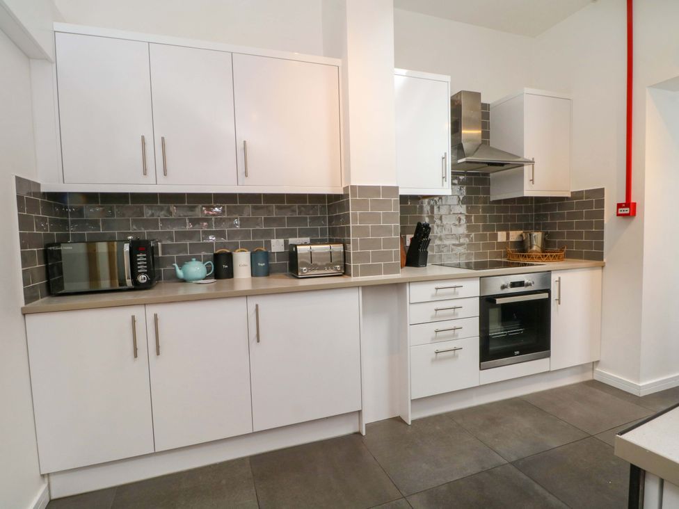A kitchen with appliances and cabinets at Broad Beams Parkgate near Neston