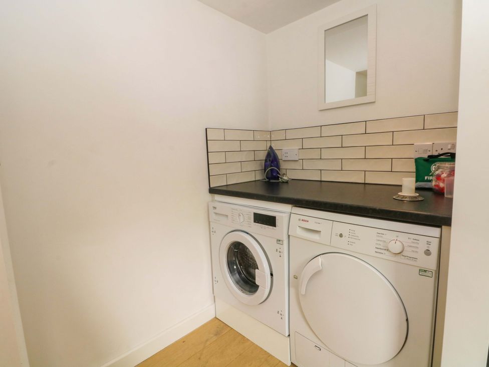 A laundry room with a washing machine and dryer at Broad Beams Parkgate near Neston