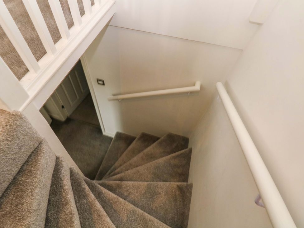 A staircase leading down with a handrail at Broad Beams Parkgate near Neston