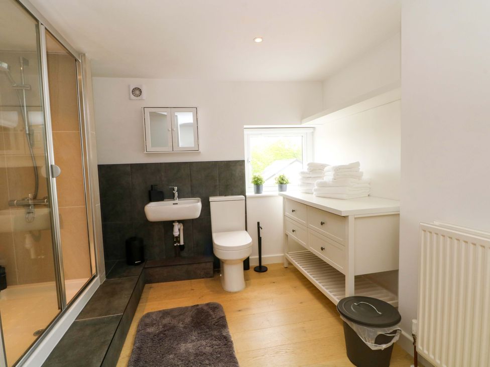 A bathroom with a shower and sink at Broad Beams Parkgate near Neston