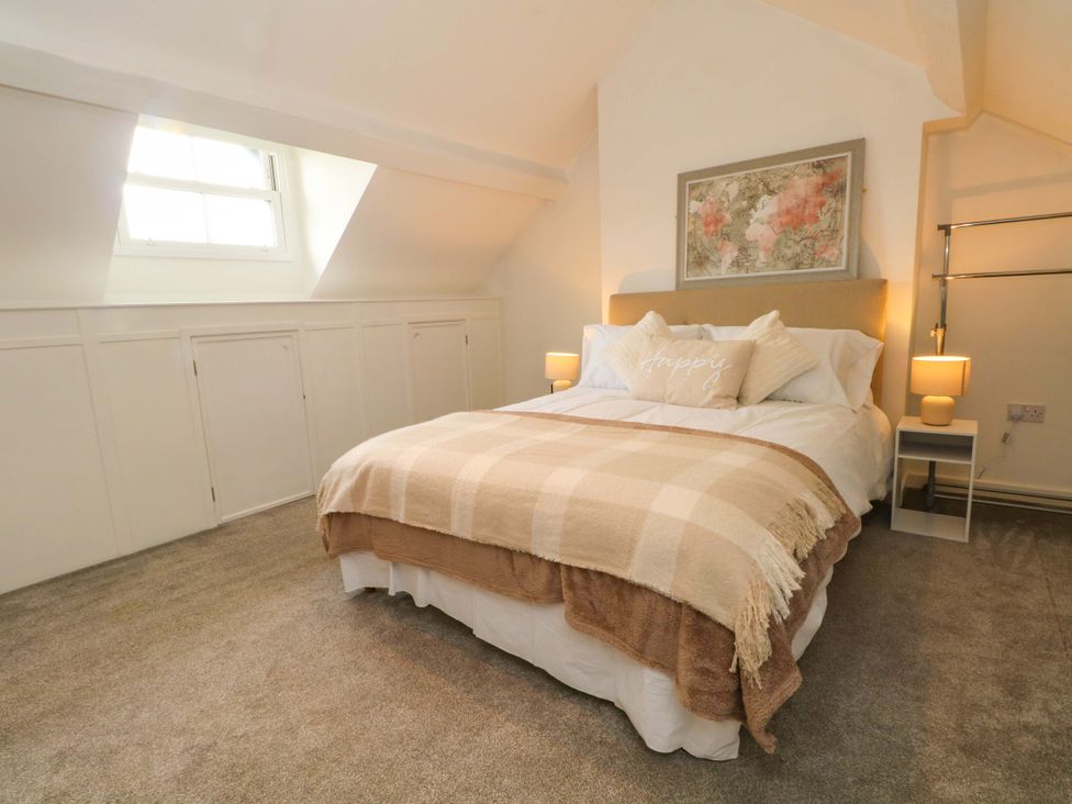 A bedroom with a bed and bedside tables at Broad Beams in Parkgate near Neston
