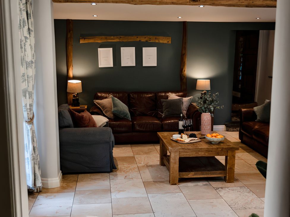 A living room with a sofa and coffee table at Carrholme Cottage Settle