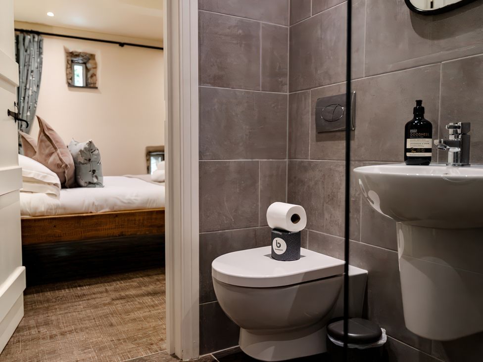 A bathroom with a toilet and sink at Carrholme Cottage in Settle