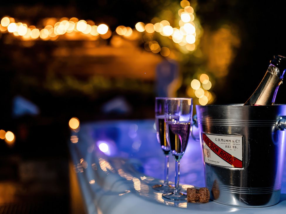 Spa with champagne bucket and glasses in an outdoor area at Carrholme Cottage Settle
