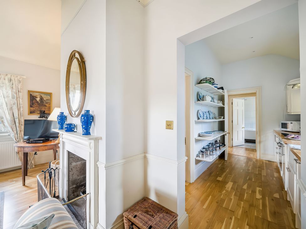 A hallway with a table and mirror at Mappowder Cottage in Buckland Newton near Dorchester