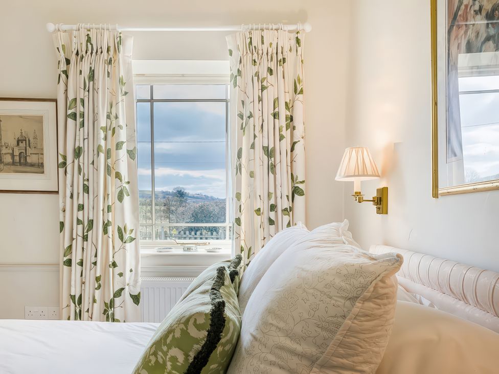A bedroom with a window and bed at Mappowder Cottage Buckland Newton near Dorchester