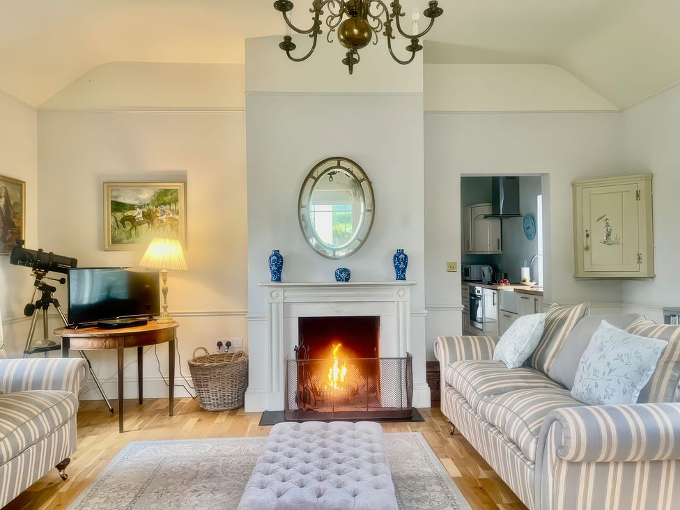 A living room with a fireplace and television at Mappowder Cottage Buckland Newton near Dorchester