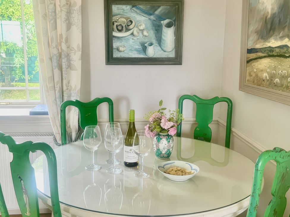 A dining room with a table set for drinks at Mappowder Cottage in Buckland Newton near Dorchester