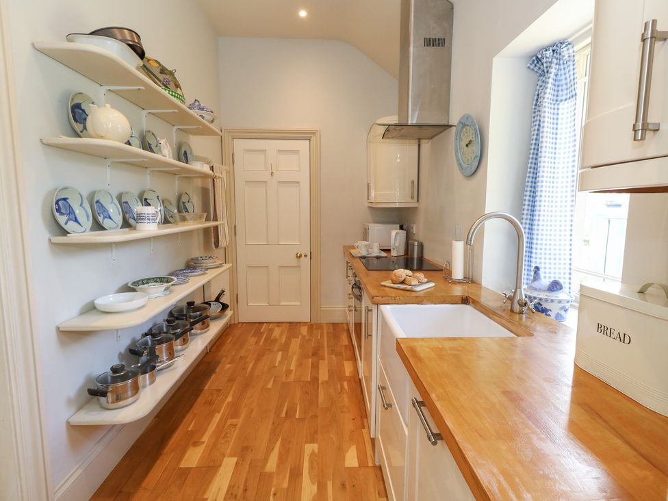 A kitchen with shelves and cooking pots at Mappowder Cottage Buckland Newton near Dorchester