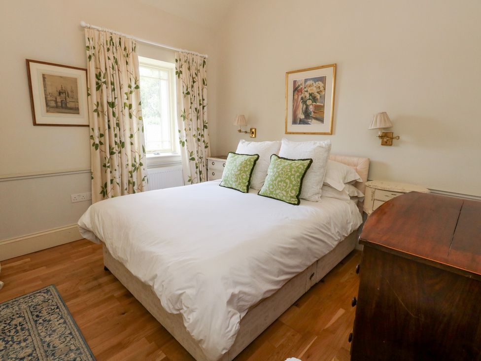 A bedroom with a bed and bedside tables at Mappowder Cottage Buckland Newton near Dorchester