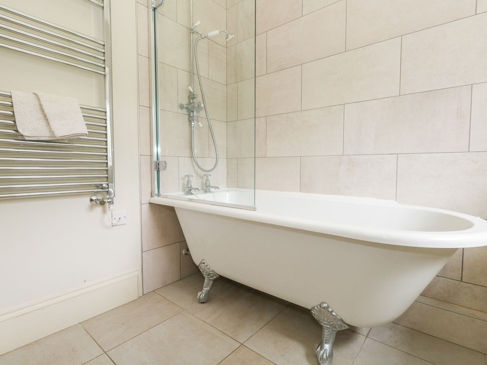 A bathroom with a bathtub and shower at Mappowder Cottage Buckland Newton near Dorchester