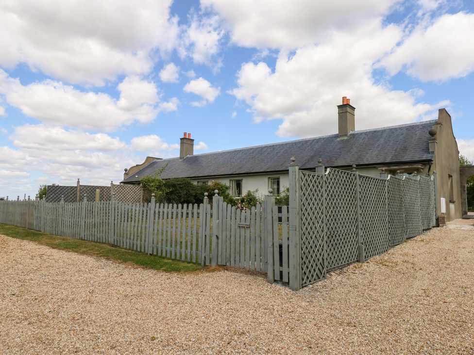 A house with a surrounding fence and garden at Mappowder Cottage in Buckland Newton near Dorchester