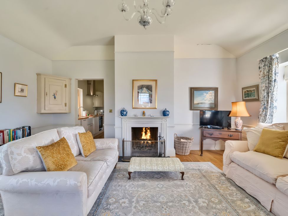 A living room with a fireplace and television at Maple Cottage in Buckland Newton near Dorchester