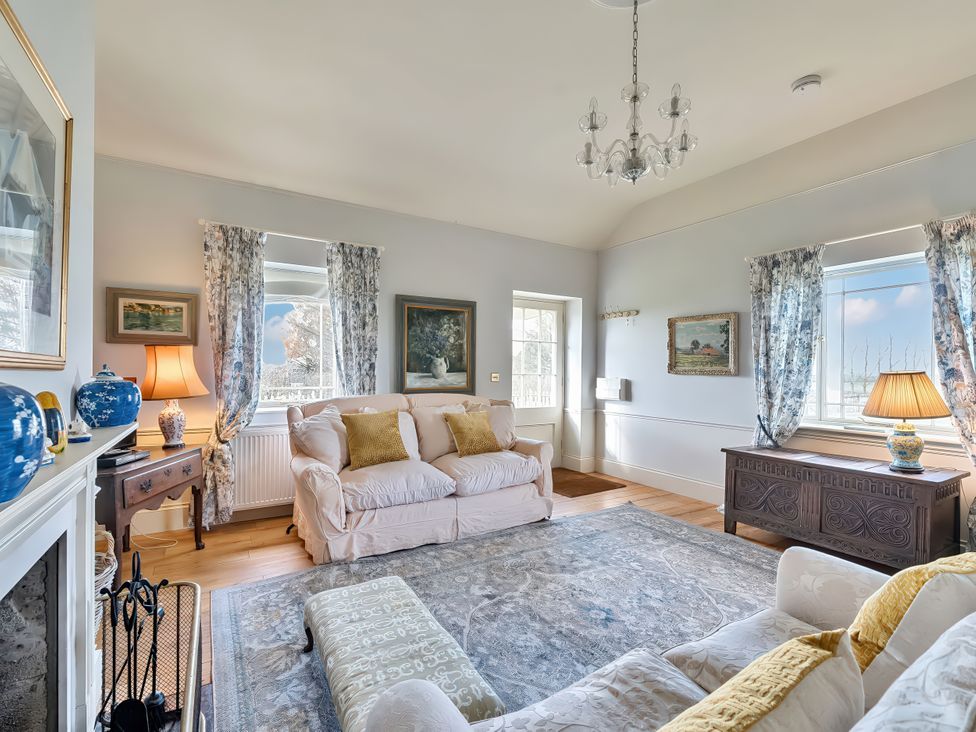 A living room with a sofa and armchair at Maple Cottage Buckland Newton near Dorchester