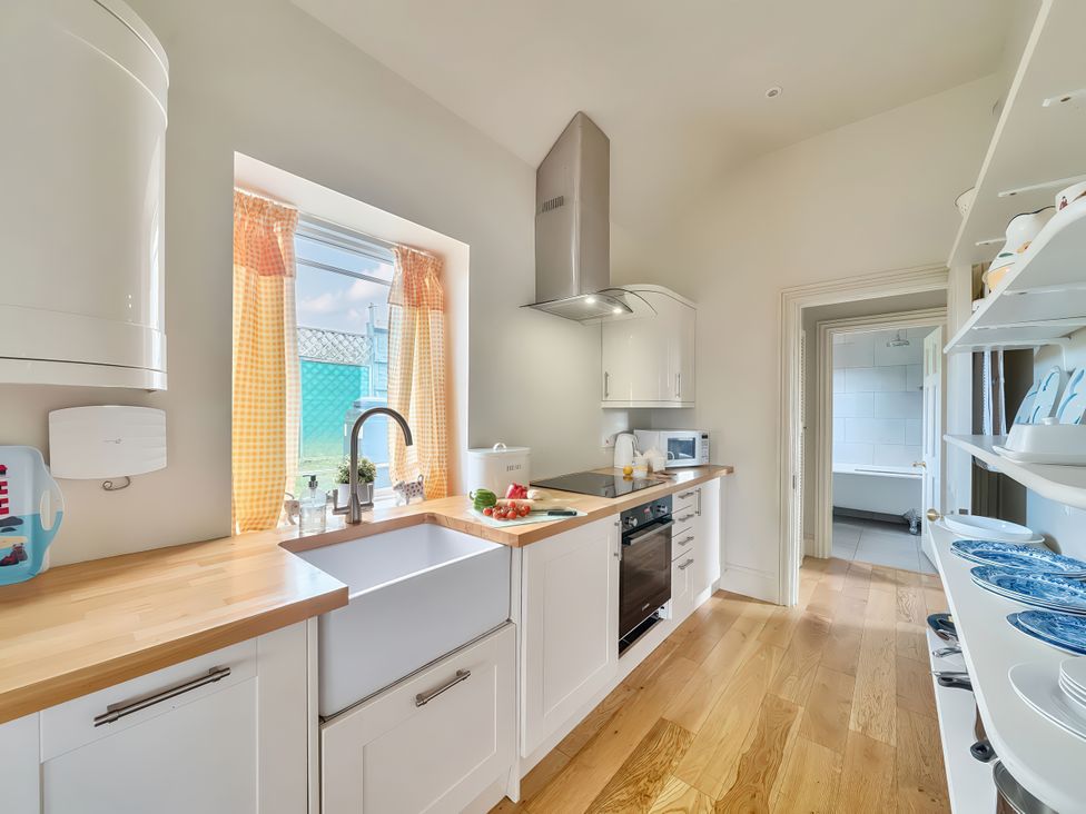 A kitchen with a sink and stove at Maple Cottage Buckland Newton near Dorchester