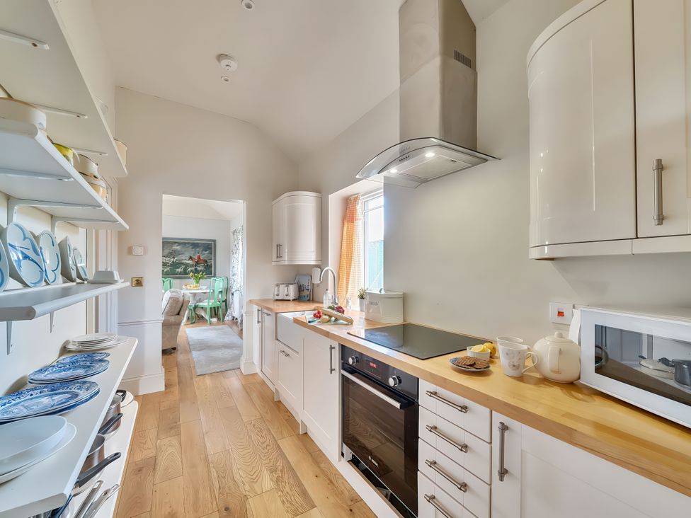 A kitchen with a countertop and appliances at Maple Cottage in Buckland Newton near Dorchester