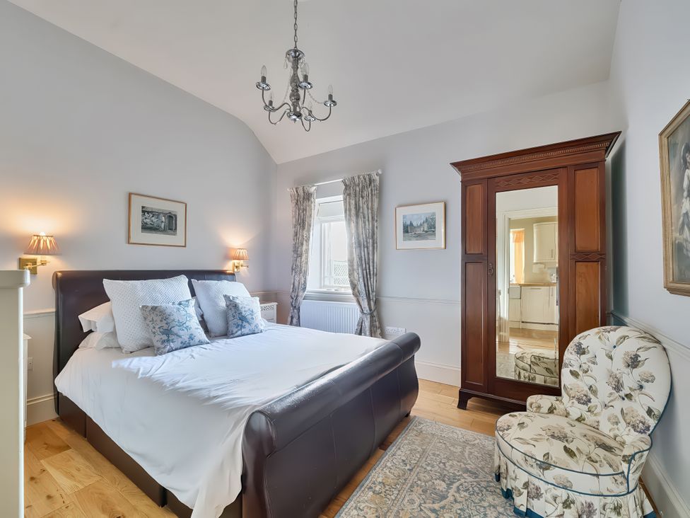 A bedroom with a bed and wardrobe at Maple Cottage Buckland Newton near Dorchester