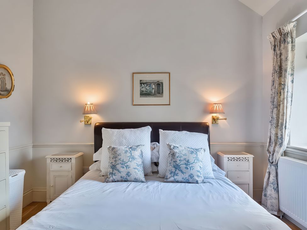 A bedroom with a bed and bedside table at Maple Cottage in Buckland Newton near Dorchester