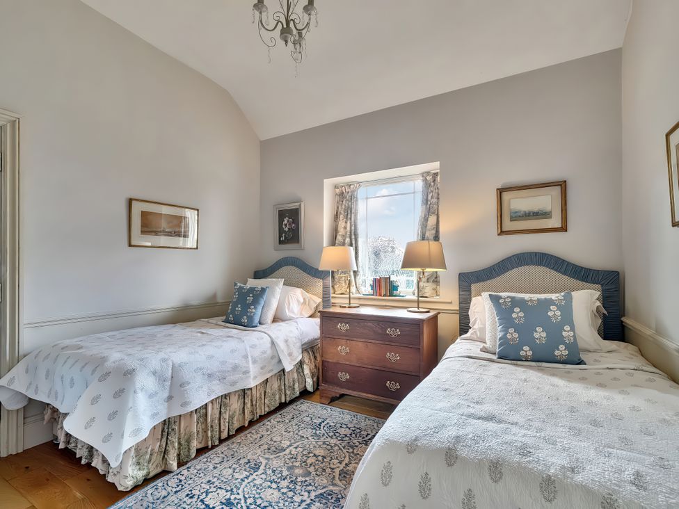 A bedroom with two beds and a dresser at Maple Cottage Buckland Newton near Dorchester