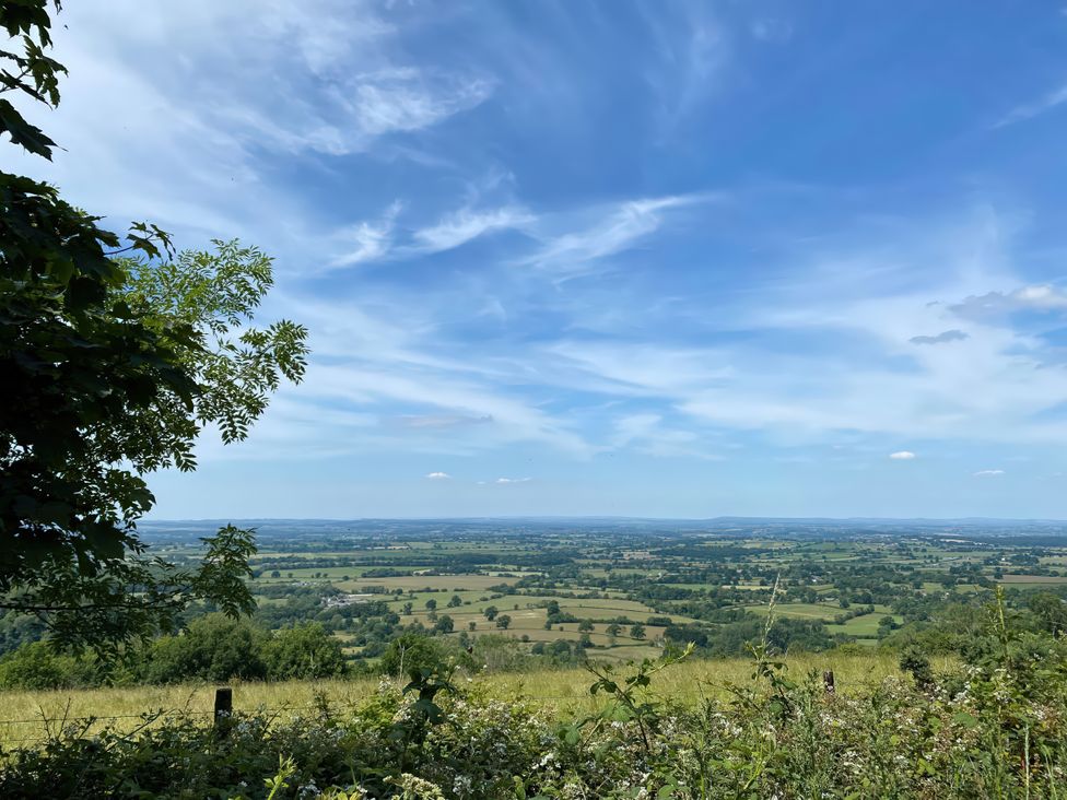 A view of fields and hills under a cloudy sky at Maple Cottage Buckland Newton near Dorchester
