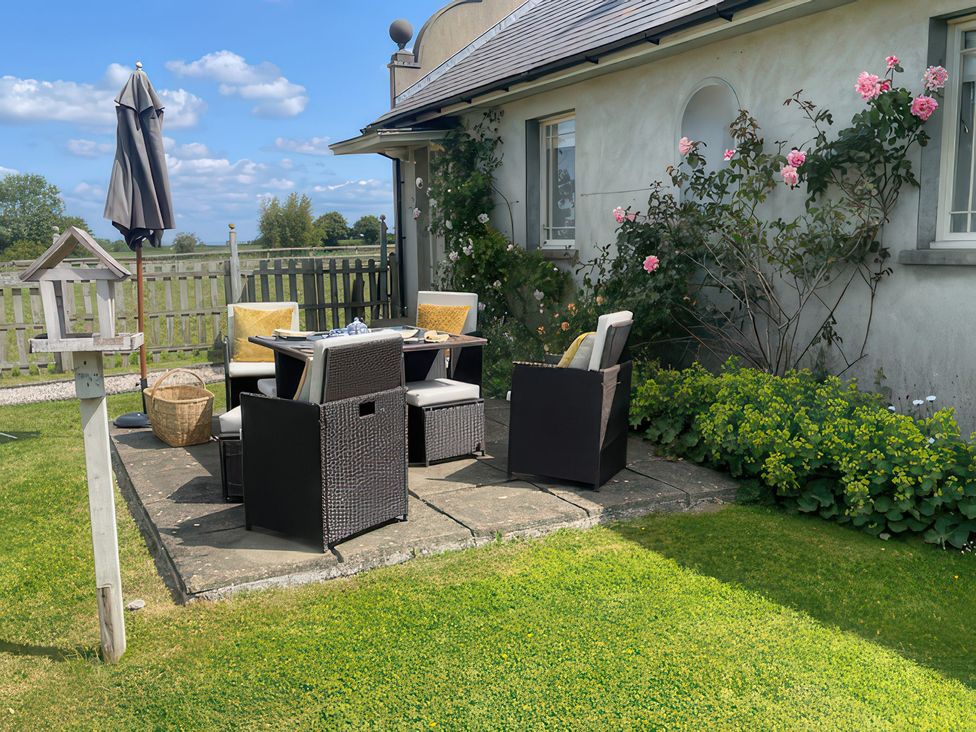 An outdoor seating area with a table and chairs at Maple Cottage in Buckland Newton near Dorchester