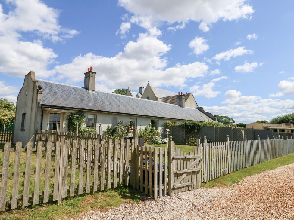 A house with a fence and garden at Maple Cottage Buckland Newton near Dorchester