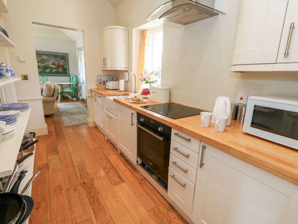 A kitchen with a countertop and appliances at Maple Cottage Buckland Newton near Dorchester