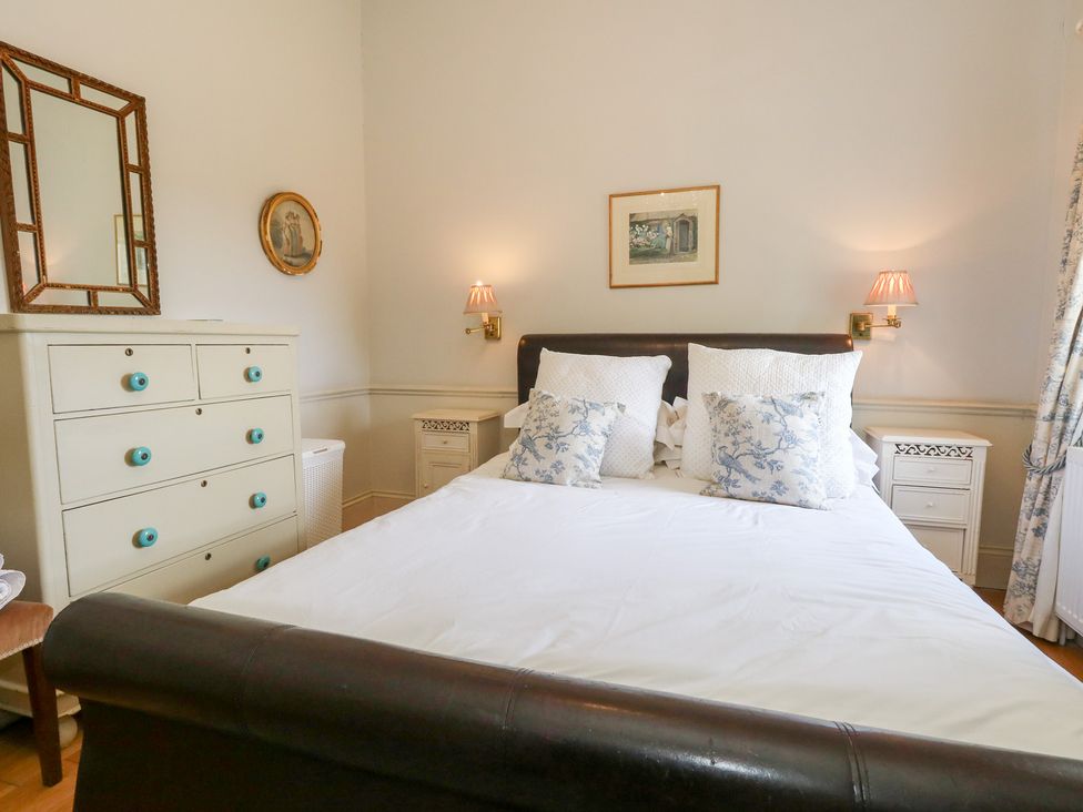 A bedroom with a bed and dresser at Maple Cottage Buckland Newton near Dorchester