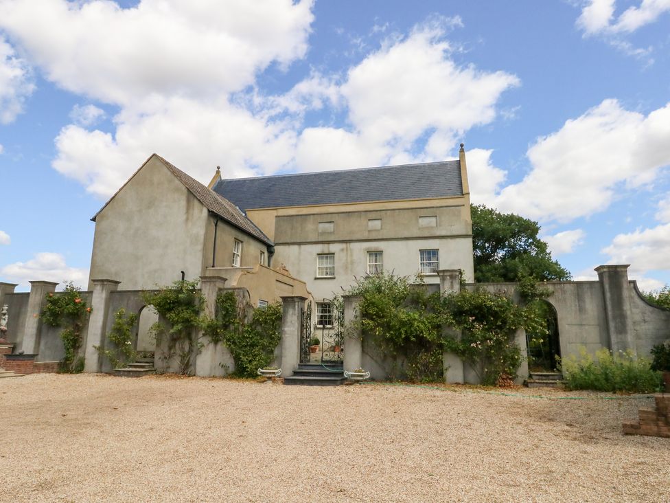 A house with a garden and stone wall at Maple Cottage in Buckland Newton near Dorchester