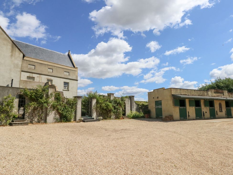 An outdoor area with a building and gravel surface at Maple Cottage in Buckland Newton near Dorchester