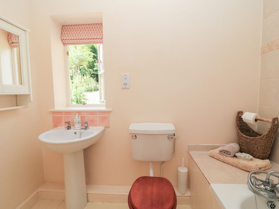 A bathroom with a sink and toilet at Upper Mill Barn, Coln St Aldwyns, near Bibury