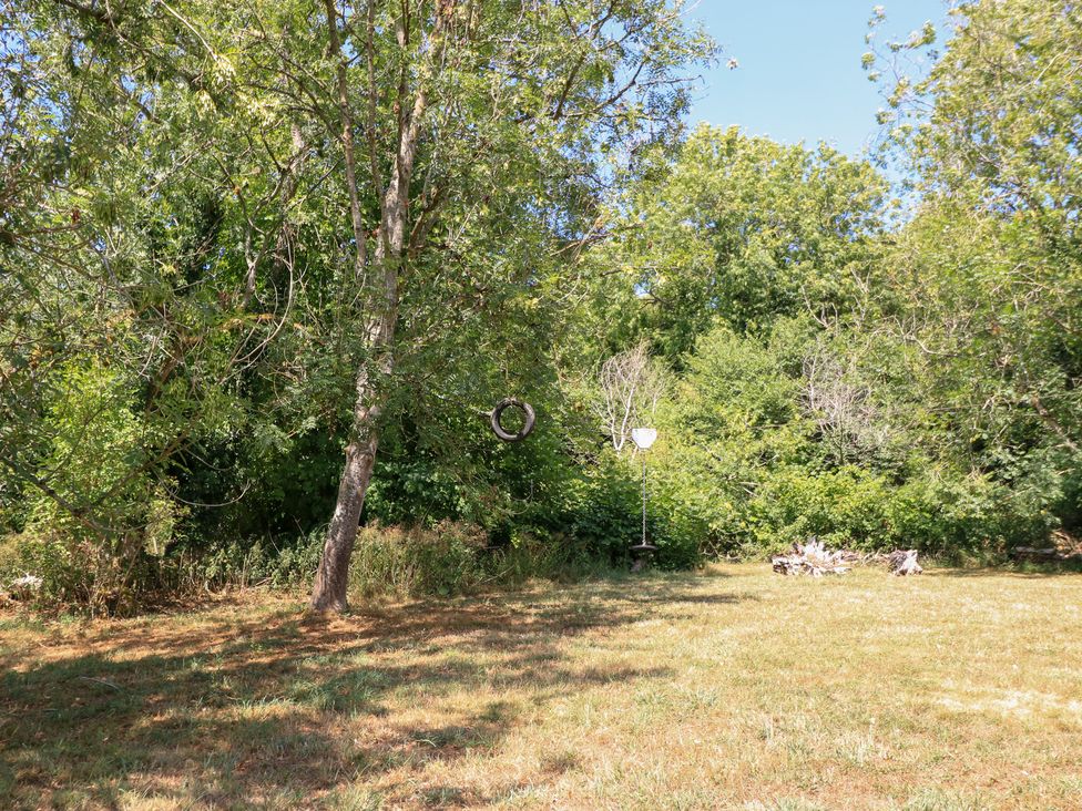 An outdoor area with a tree and tire swing at Upper Mill Barn, Coln St Aldwyns, near Bibury