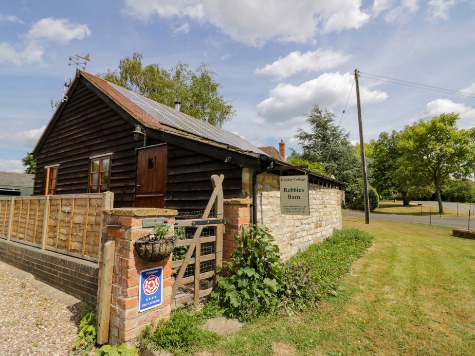 An outdoor view of a barn with a sign at Robbie's Barn in Fulready near Stratford-upon-Avon