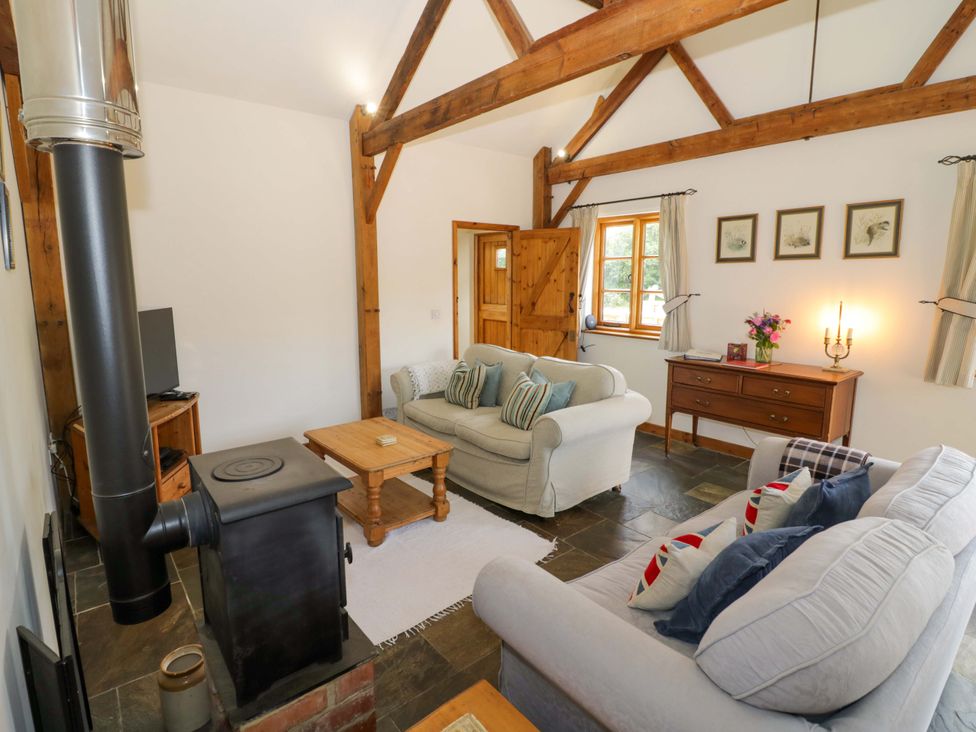 A living room with a sofa and coffee table at Robbie's Barn Fulready near Stratford-upon-Avon