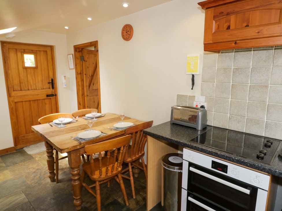 A kitchen with a dining table and chairs at Robbie's Barn in Fulready near Stratford-upon-Avon
