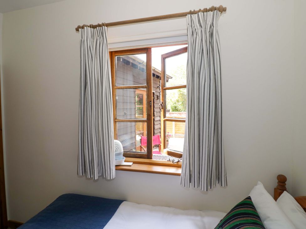 A bedroom with a window and bed at Robbie's Barn Fulready near Stratford-upon-Avon