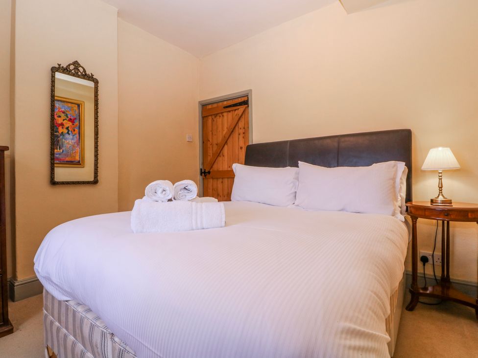 A bedroom with a bed and towels at Elm View in Chipping Campden