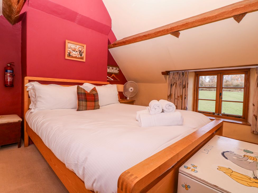 A bedroom with a bed and a window at Elm View Chipping Campden