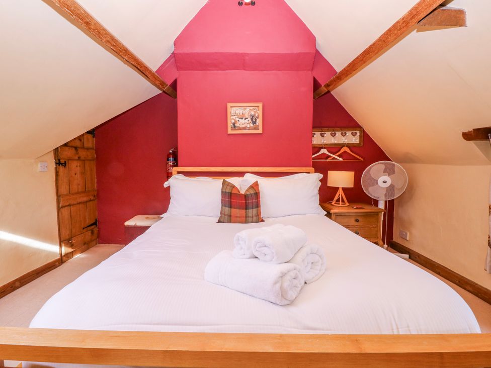 A bedroom with a bed and bedside table at Elm View in Chipping Campden