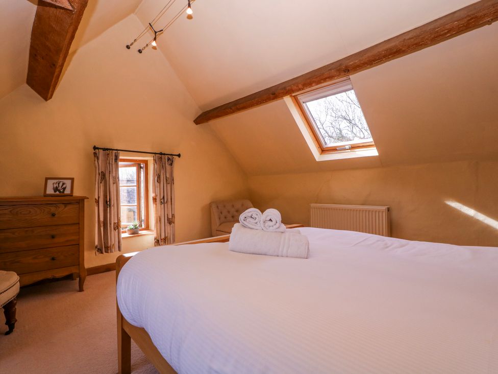 A bedroom with a bed and dresser at Elm View in Chipping Campden