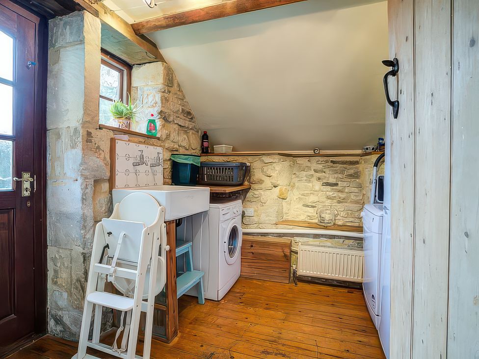 A laundry room with a washing machine and drying rack at Elm View in Chipping Campden