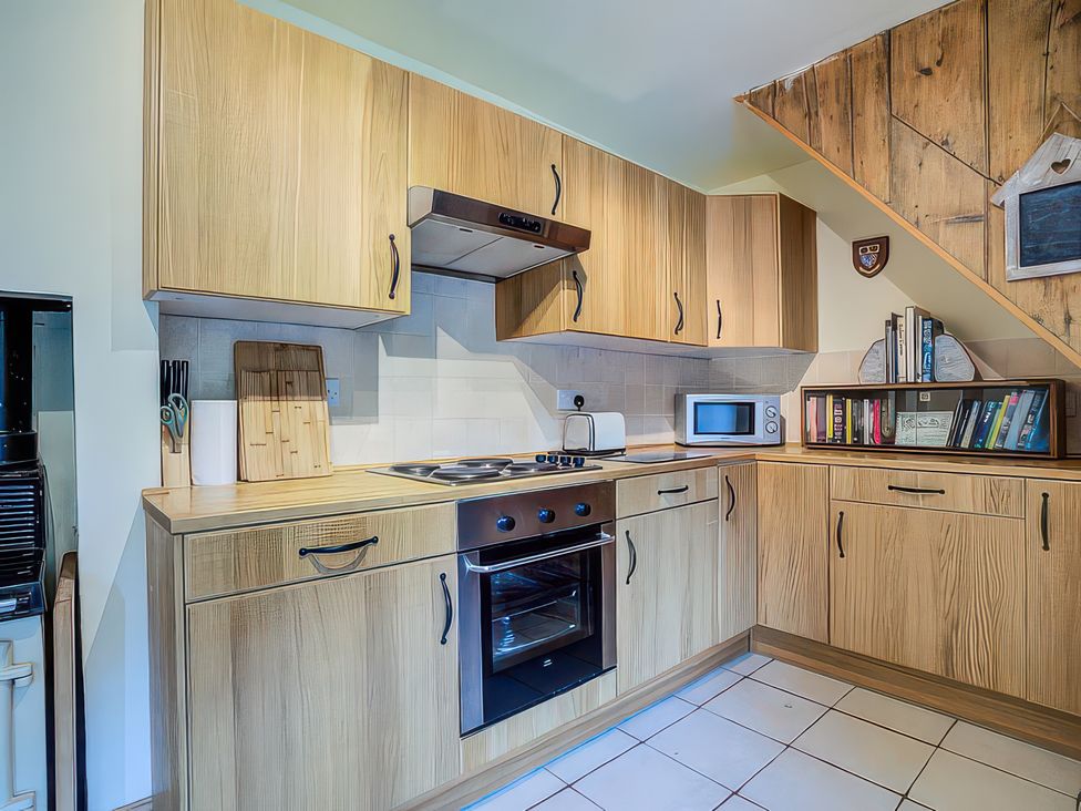 A kitchen with wooden cabinets and appliances at Elm View Chipping Campden