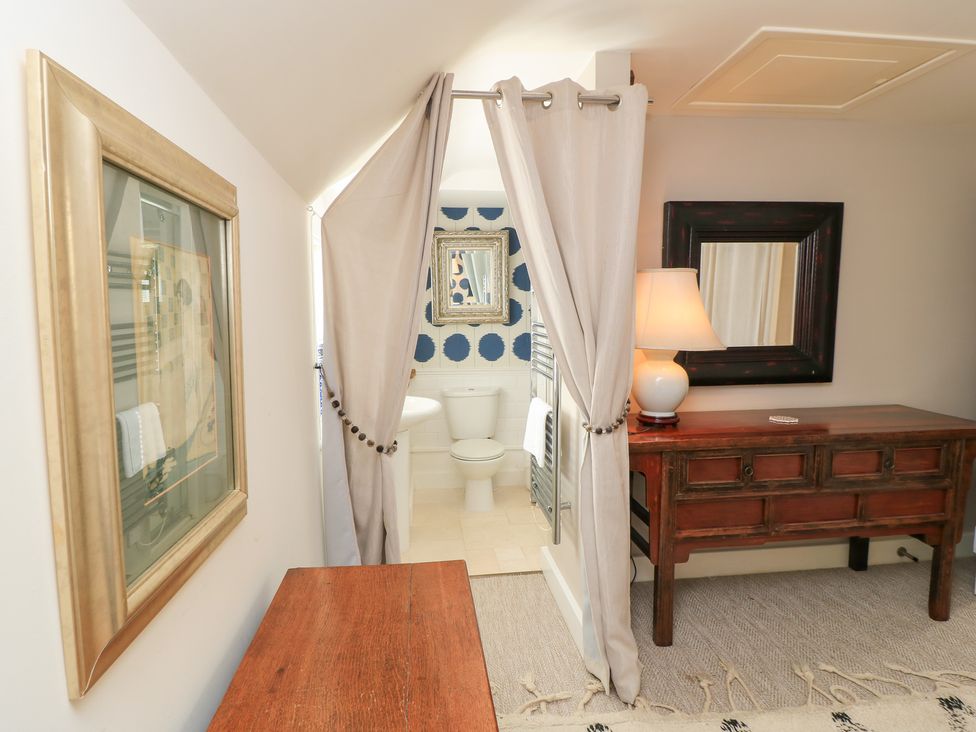 A bathroom with a toilet and shower area at Fairview Cottage Milton-Under-Wychwood