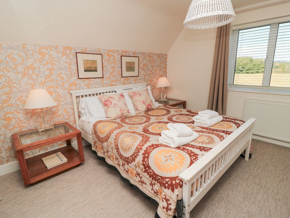 A bedroom with a bed and nightstand at Fairview Cottage Milton-Under-Wychwood