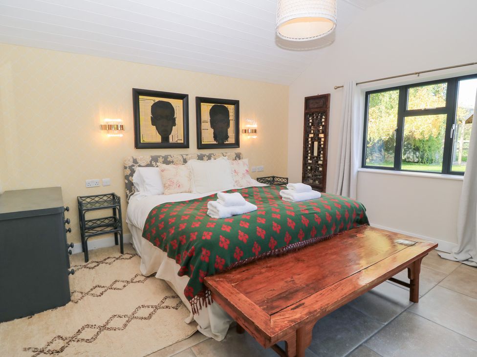 A bedroom with a bed and decorative items at Fairview Cottage Milton-Under-Wychwood