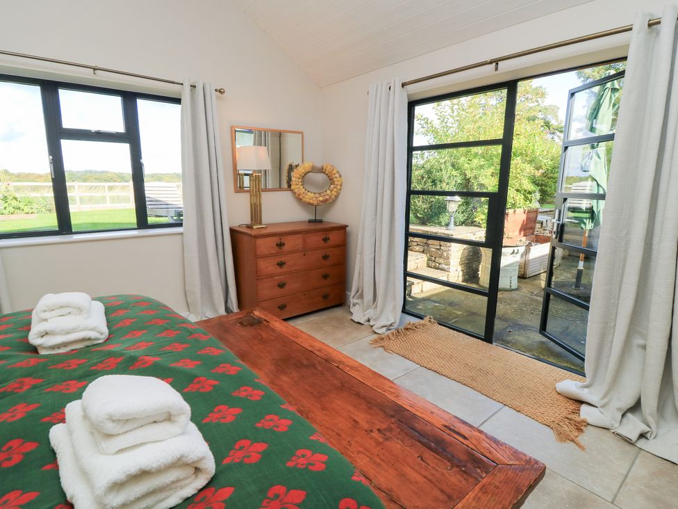 A bedroom with a bed and dresser at Fairview Cottage in Milton-Under-Wychwood
