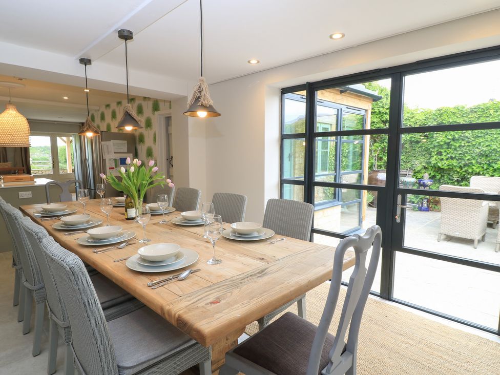 A dining room with a table set for a meal at Fairview Cottage in Milton-Under-Wychwood