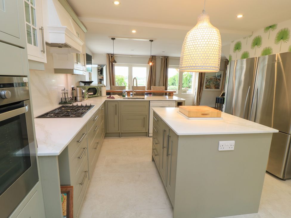 A kitchen with a large island and stainless steel appliances at Fairview Cottage in Milton-Under-Wychwood