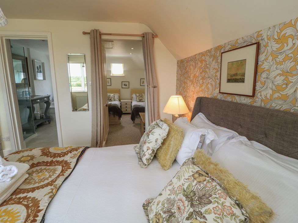 A bedroom with a bed and lamp at Fairview Cottage in Milton-Under-Wychwood